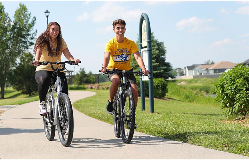 two students riding bikes on the Hike and Bike Trail